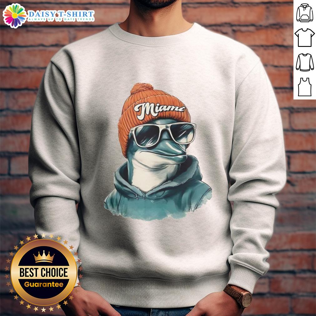 Good Miami Dolphins Mascot Wearing A Beanie And Sunglasses Sweatshirt Miami Dolphins mascot wearing a beanie, sunglasses, and a sweatshirt, showcasing team spirit in a fun outfit.