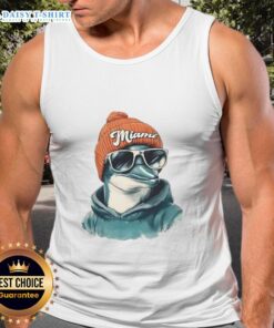 Miami Dolphins mascot in a beanie, sunglasses, and tank top, showcasing team spirit at a game.