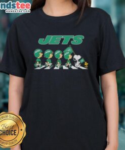 Alt Text: Good New York Jets X Peanuts Snoopy and Friends Abbey Road Ladies Tee featuring iconic cartoon characters in Jets gear.
