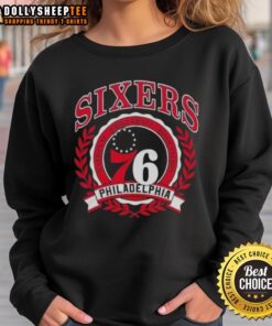 Alt Text: Stylish Philadelphia 76ers National Basketball Association crest sweatshirt featuring team colors and logo.