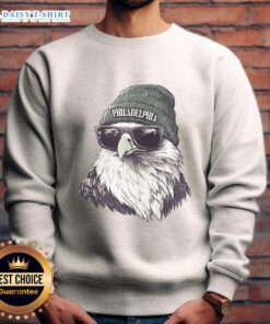 Philadelphia Eagles mascot in a beanie and sunglasses, wearing a sweatshirt, ready to cheer for the team.