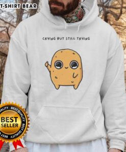 Good Sad Nuggie mascot cartoon in a hoodie, crying but trying to smile, perfect for a heartwarming design.