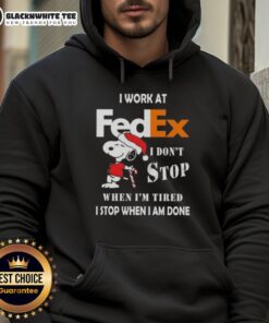 Good Snoopy Christmas hoodie with 'I work at FedEx, I don't stop when I'm tired, I stop when I'm done' slogan.