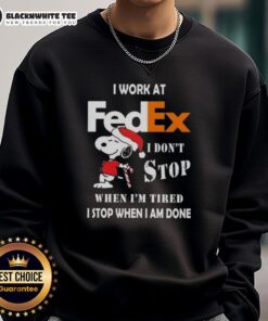 Good Snoopy Christmas sweatshirt featuring 'I work at FedEx, I don't stop when I'm tired, I stop when I'm done' slogan.
