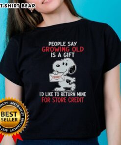 Funny ladies' tee featuring Snoopy with the quote about growing old as a gift, perfect for humor and nostalgia lovers.