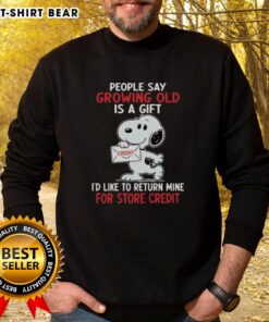 Funny sweatshirt featuring Snoopy with 'Growing old is a gift, I'd like to return mine for store credit' quote.