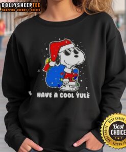 Alt Text: Good Snoopy in a Santa hat on a Merry Christmas sweatshirt for a cool yule holiday celebration.