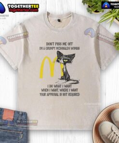 Grumpy woman in a McDonald's-themed shirt, embodying a 'good tired' cat vibe, humorously asserting her independence.