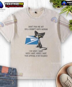 Grumpy USPS woman wearing a 'Good Tired Cat' t-shirt, showcasing her fierce attitude and humor in a playful pose.