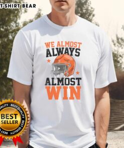 Funny football fan T-shirt with 'Good We Almost Always Almost Win' slogan, perfect for sports enthusiasts and game day.