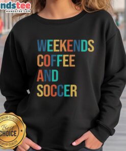 Cozy 'Good Weekends Coffee and Soccer' sweatshirt displayed on a wooden table, perfect for casual outings or relaxing at home.