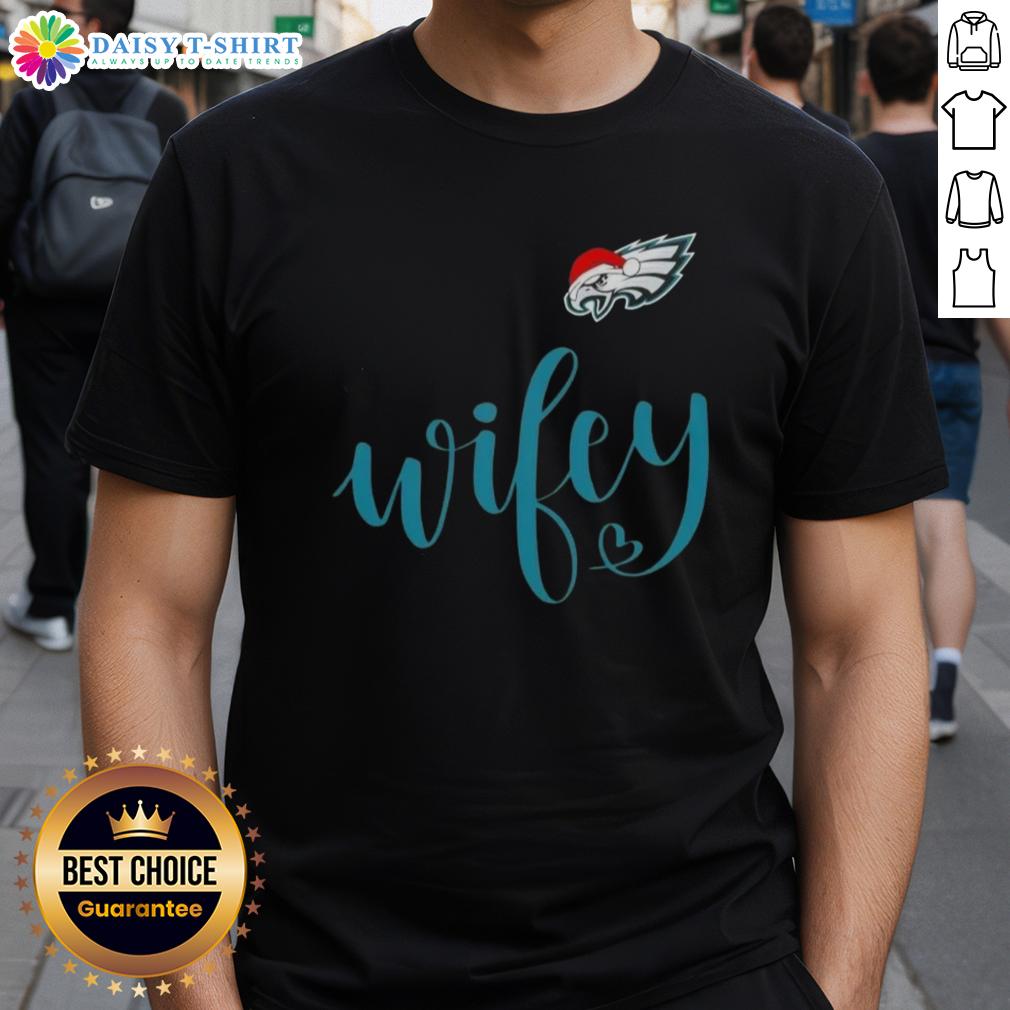 Good Wifey Philadelphia Eagles Santa Hat Merry Christmas T Shirt Good Wifey Philadelphia Eagles Santa Hat Merry Christmas T-Shirt featuring festive design for Eagles fans celebrating the holidays.