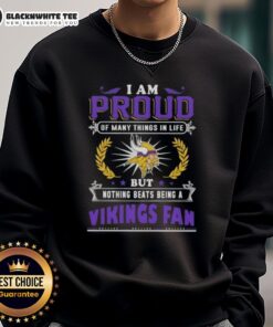 Happy Minnesota Vikings fan wearing a sweatshirt that says 'I Am Proud Of Many Things But Nothing Beats Being A Vikings Fan.'
