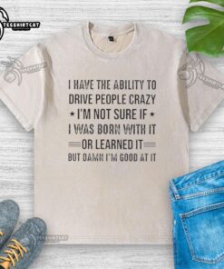 Happy person wearing a 'I Can Drive People Crazy' washed t-shirt, showcasing a playful, humorous style.