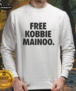Happy man wearing a Free Kobbie Mainoo sweatshirt, celebrating his brother Kobbie Mainoo's achievements.