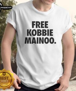 Happy Man United fan wearing a 'Free Kobbie Mainoo' t-shirt, celebrating his brother Kobbie Mainoo's impact in football.
