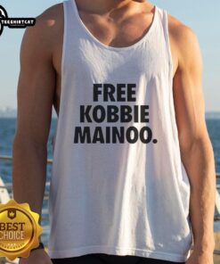 Happy Manchester United fan wearing a Free Kobbie Mainoo tank top, celebrating his brother's achievements.
