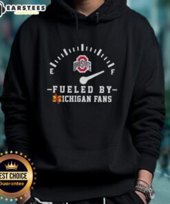 Alt Text: Happy Ohio State Buckeyes fans wearing Xichigan hoodie, celebrating victory at a football game.