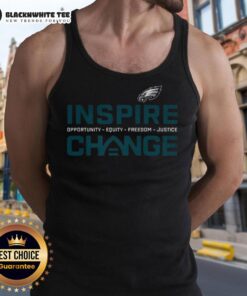 Happy Philadelphia Eagles fans wearing 'Inspire Change Equity Justice' tank tops at a game, promoting social justice.