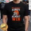 Happy football fan wearing 'Almost Always Almost Win' T-shirt, showcasing humor and team spirit in sports fashion.