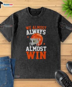 Funny football fan wearing a 'Happy We Almost Always Almost Win' washed t-shirt, showcasing team spirit and humor.