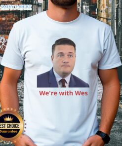 Happy Wes Streeting wearing 'We're With Wes' T-shirt, showcasing support for the politician in a vibrant, engaging setting.