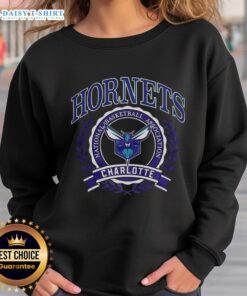 Retro Charlotte Hornets NBA logo sweatshirt with laurel wreath frame, perfect for basketball fans and collectors.