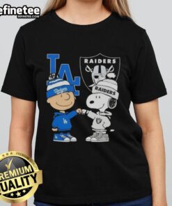 Awesome Charlie Brown fist bump with Snoopy, showcasing Dodgers and Raiders spirit on a stylish ladies tee in Los Angeles.