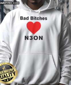 Stylish woman wearing a 'Nice Bad Bitches Love Neon Hoodie' in a vibrant urban setting, showcasing modern street fashion.