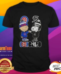 Charlie Brown and Snoopy fist bump on a Chicago Cubs vs White Sox t-shirt, perfect for city sports fans.