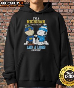 Charlie Brown and Snoopy fist bump in 'I'm a Michigan on Saturday and a Detroit Lions on Sunday' skyline hoodie.