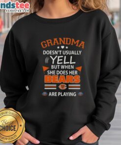 Nice grandma wearing a Chicago Bears sweatshirt, showing her passion for football, rarely yells during games.
