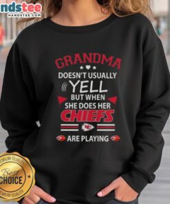 Nice grandma wearing a Kansas City Chiefs sweatshirt, showing her fierce spirit during a football game.