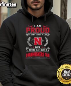 Cozy hoodie with 'Proud Nebraska Cornhuskers Fan' slogan, perfect for showing team spirit and support for Nebraska athletics.