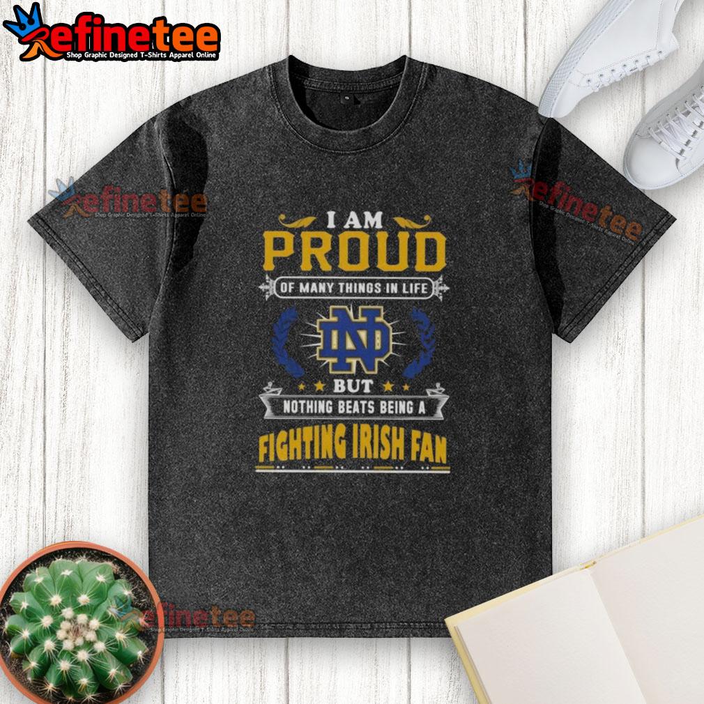 nice-i-am-proud-of-many-things-in-life-but-nothing-beats-being-a-notre-dame-fighting-irish-fan-washed-t-shirt Alt Text: Proud Notre Dame Fighting Irish fan wearing a washed t-shirt showcasing love for the team and its spirit.