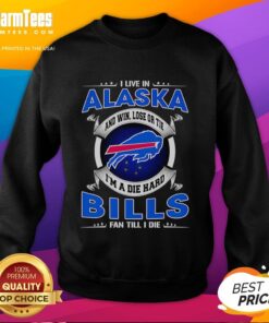 Alaska fan wearing a Buffalo Bills sweatshirt, showcasing pride with 'Win, Lose or Tie, I'm a Buffalo Bills fan' slogan.