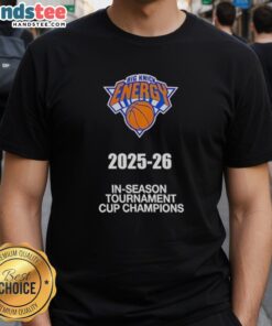 Alt Text: 2025-26 New York Knicks In-Season Tournament Cup Champions T-Shirt featuring team logo and vibrant design.