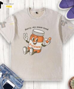 Cartoon design on a washed t-shirt featuring 'Please Be Patient, Sorry My Mom Took Tylenol' message for humorous appeal.