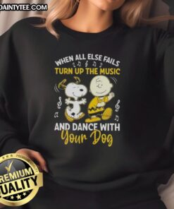 Snoopy and Charlie Brown on a sweatshirt, with the quote 'When all else fails, turn up the music and dance with your dog.'