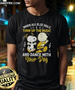 Alt Text: Snoopy and Charlie Brown graphic on a T-shirt with the phrase 'When All Else Fails, Turn Up The Music and Dance with Your Dog.'