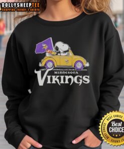 Snoopy and Woodstock riding in a Minnesota Vikings football car on a cozy sweatshirt design.