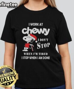 Alt Text: Snoopy graphic on a Christmas ladies tee with 'I work at Chewy, I don't stop when I'm tired' slogan.