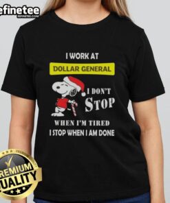 Christmas Ladies Tee featuring Snoopy with the phrase 'I work at Dollar General, I don't stop when I'm tired'.