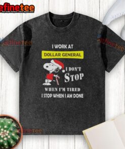 Alt Text: Snoopy graphic on a Christmas t-shirt reading 'I work at Dollar General, I don't stop when I'm tired, I stop when I'm done.'