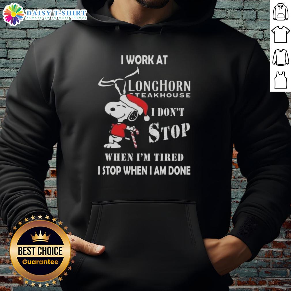 Nice Snoopy I Work At Longhorn Steakhouse I Don't Stop When I'm Tired I Stop When I Am Done Christmas Hoodie Alt Text: Snoopy Christmas hoodie with 'I work at Longhorn Steakhouse, I don't stop when I'm tired, I stop when I'm done' design.