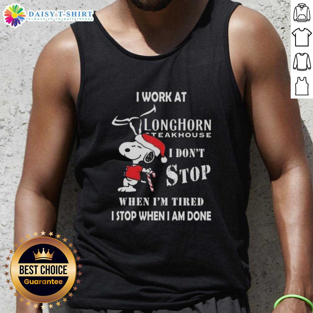 Nice Snoopy I Work At Longhorn Steakhouse I Don't Stop When I'm Tired I Stop When I Am Done Christmas Tank Top Alt Text: Snoopy Christmas tank top with I Work At Longhorn Steakhouse and motivational quote for holiday spirit.