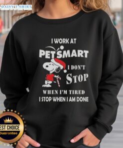 Snoopy Christmas sweatshirt with 'I Work At PetSmart, I Don't Stop When I'm Tired, I Stop When I'm Done' slogan.