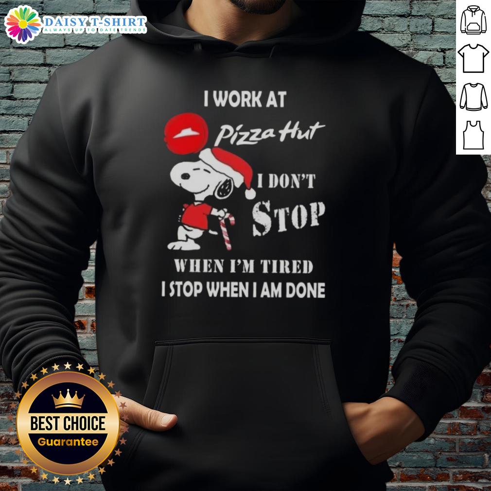 Nice Snoopy I Work At Pizza Hut I Don't Stop When I'm Tired I Stop When I Am Done Christmas Hoodie Alt Text: Snoopy Christmas hoodie with 'I work at Pizza Hut, I don't stop when I'm tired, I stop when I'm done' slogan.