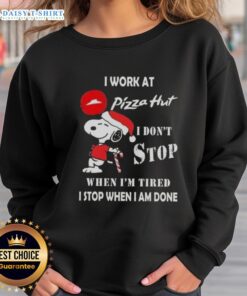 Cozy Christmas sweatshirt featuring Snoopy with the phrase 'I work at Pizza Hut, I don't stop when I'm tired'.