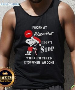 Alt Text: Snoopy wearing a Christmas tank top with the phrase I work at Pizza Hut, I don't stop when I'm tired printed.